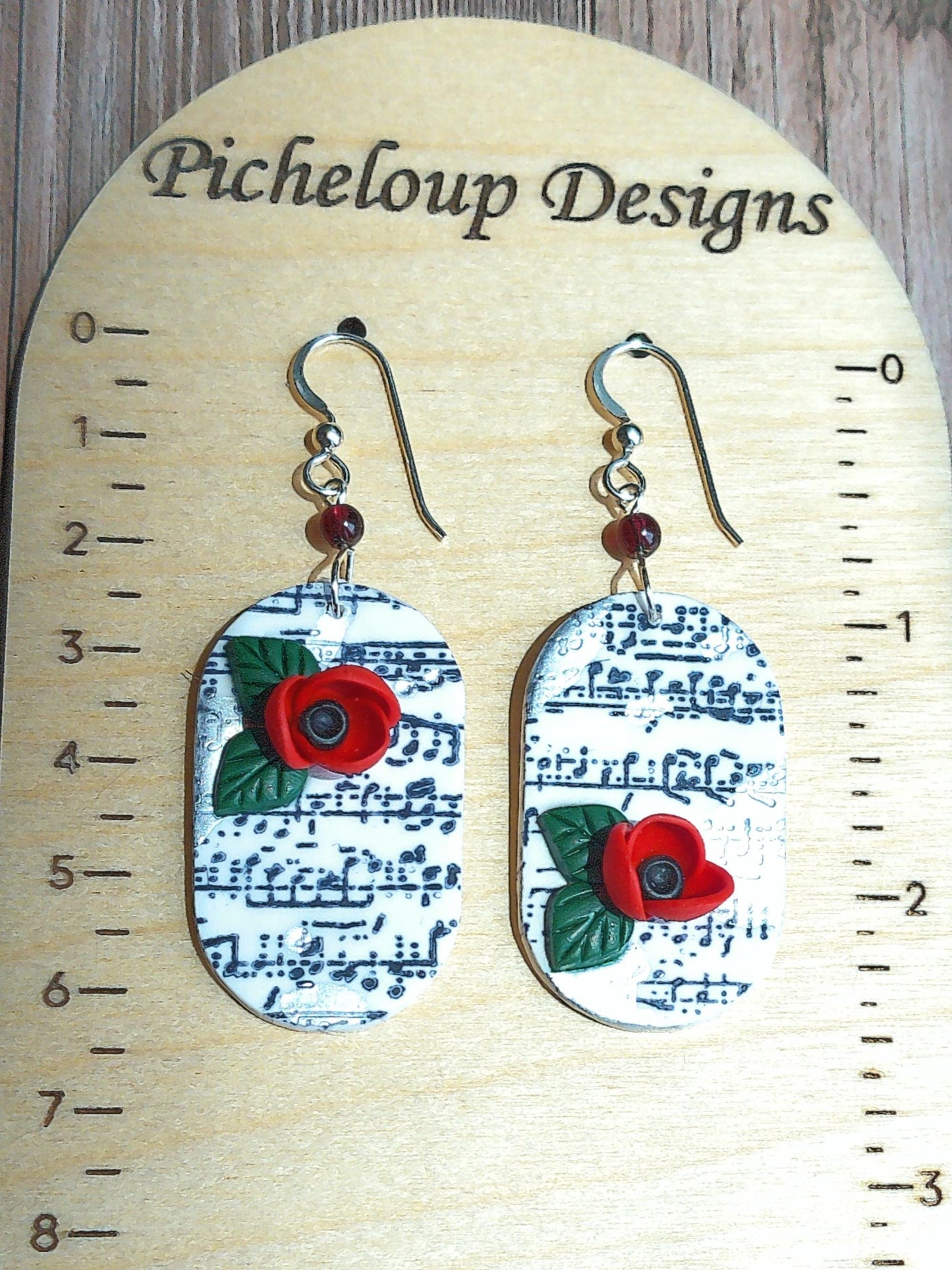 Cadence Earrings – Bold Oval Music Note Dangles with Garnet & Floral Accent