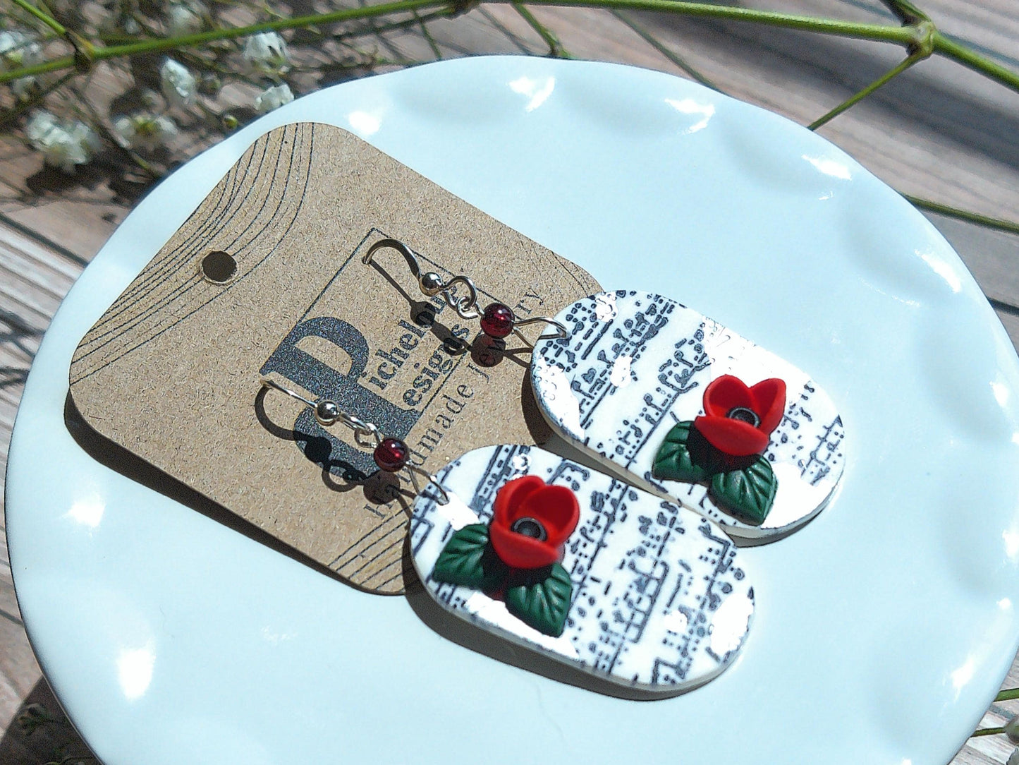 Cadence Earrings – Bold Oval Music Note Dangles with Garnet & Floral Accent